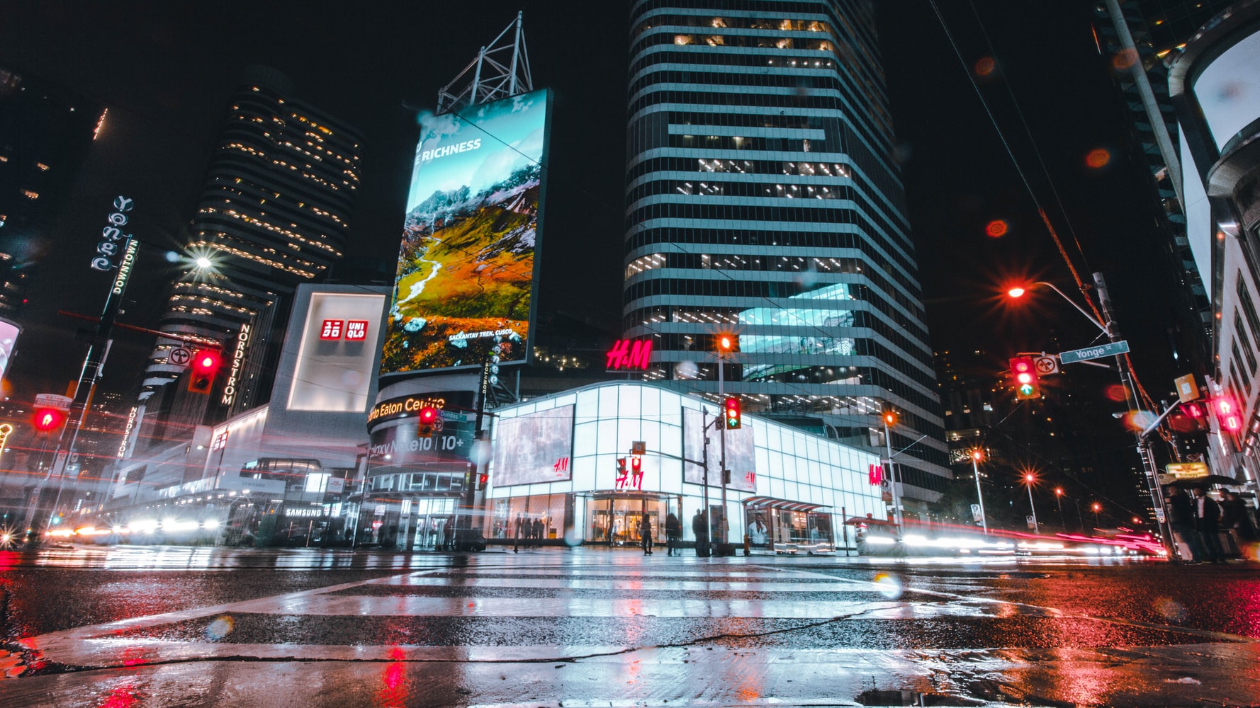 Large-format digital displays illuminating a city square at night