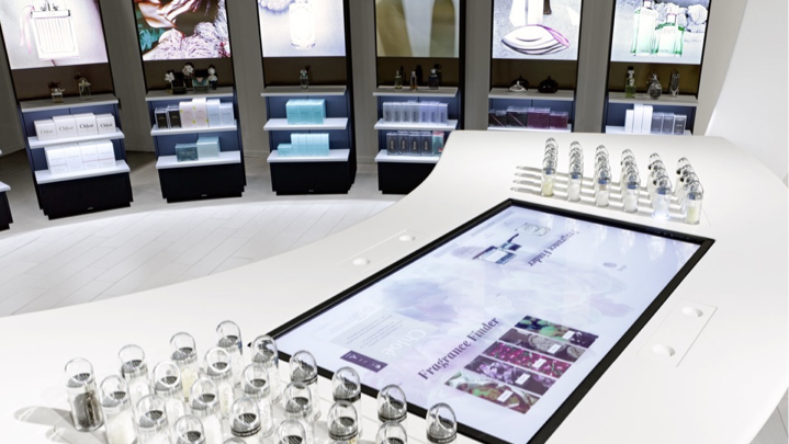 Interactive display table within a premium fragrance retail environment